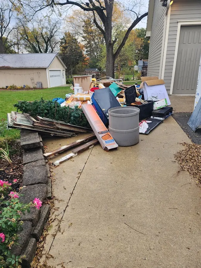 Dumpster being loaded with debris for Commercial Dumpster Rental in Grosse Pointe Farms